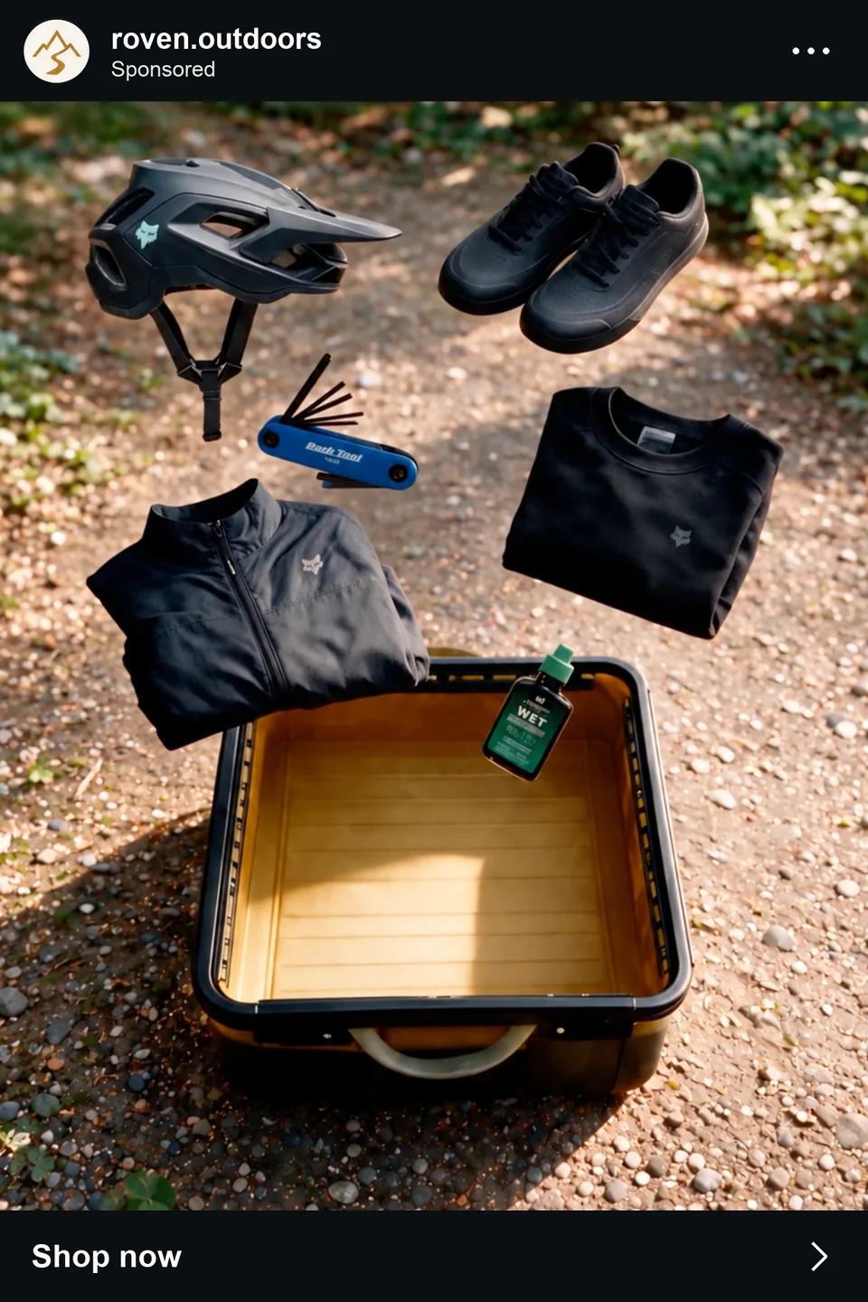 Ad creative: mountain-bike gear floating above the open tote on a forest path, fictional brand roven.outdoors